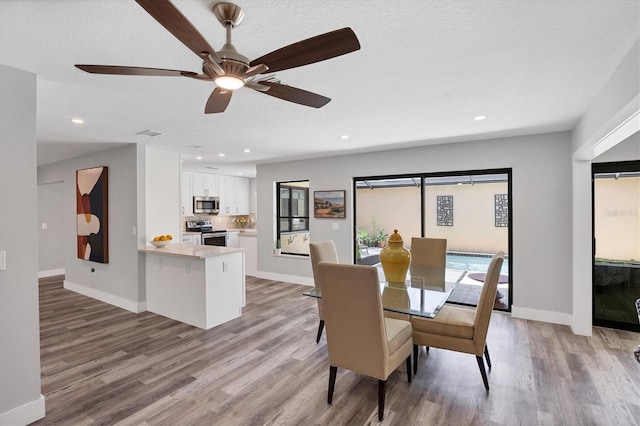 3955 Glen Oaks Manor Dr, Sarasota, FL 34232 - dining space featuring light wood-type flooring, recessed lighting, a ceiling fan, and a textured ceiling