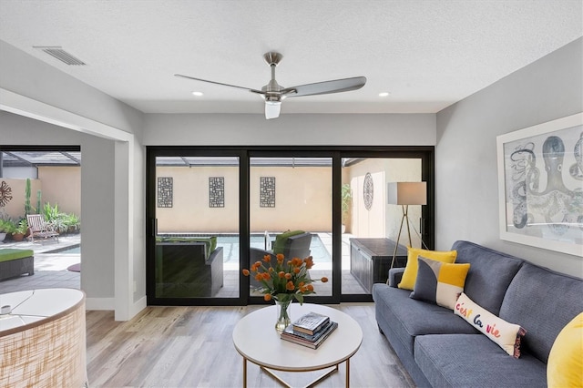 3955 Glen Oaks Manor Dr, Sarasota, FL 34232 - living room with wood finished floors, ceiling fan, recessed lighting, and a textured ceiling