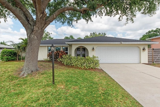 single story home featuring driveway, stucco siding, a front lawn, and a garage