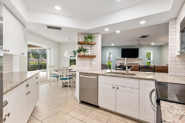 kitchen featuring a sink, stainless steel appliances, backsplash, and visible vents