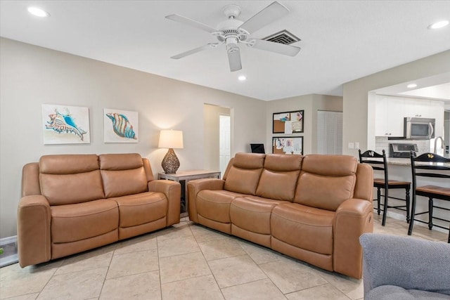 living room featuring light tile patterned floors, a ceiling fan, visible vents, and recessed lighting