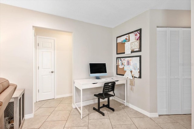 office area with light tile patterned floors and baseboards