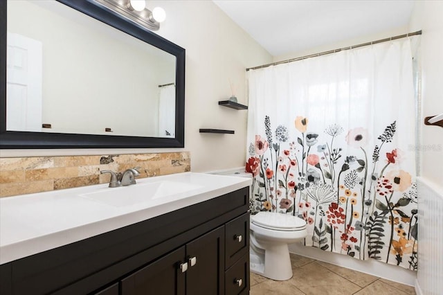 bathroom featuring toilet, tile patterned floors, and vanity