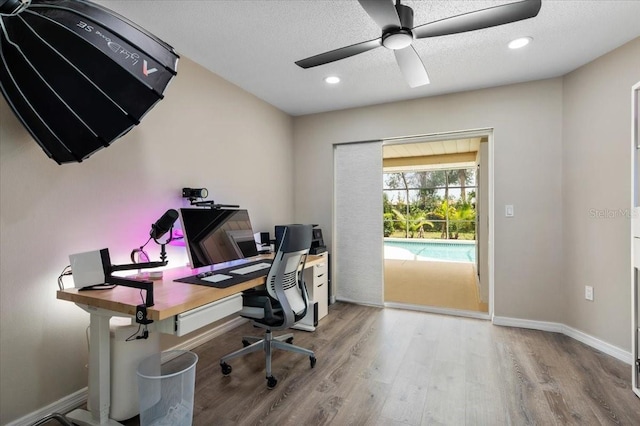 office with a ceiling fan, recessed lighting, a textured ceiling, baseboards, and wood finished floors