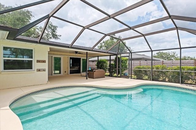pool with a patio area and a ceiling fan