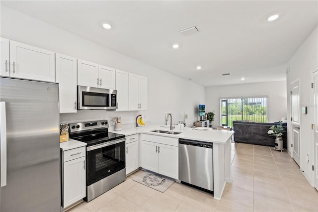 8545 Daybreak St, Sarasota, FL 34241 - kitchen featuring visible vents, a peninsula, light countertops, a sink, and appliances with stainless steel finishes