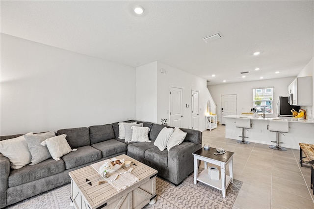 8545 Daybreak St, Sarasota, FL 34241 - living room with recessed lighting and light tile patterned floors