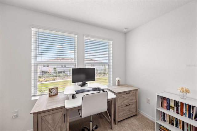 8545 Daybreak St, Sarasota, FL 34241 - office area featuring a textured ceiling, baseboards, and light carpet