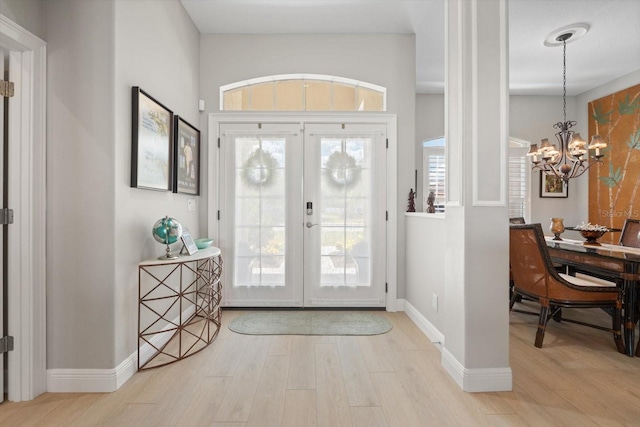 9012 Province St, Sarasota, FL 34240 - entryway with light wood-style flooring, french doors, baseboards, and healthy amount of natural light