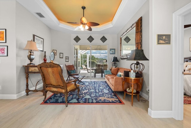 9012 Province St, Sarasota, FL 34240 - sitting room with a ceiling fan, wood finished floors, a tray ceiling, and ornamental molding