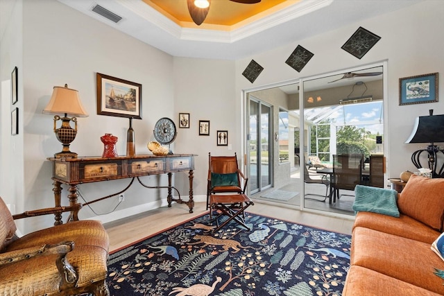 9012 Province St, Sarasota, FL 34240 - living room with a ceiling fan, wood finished floors, ornamental molding, a raised ceiling, and baseboards