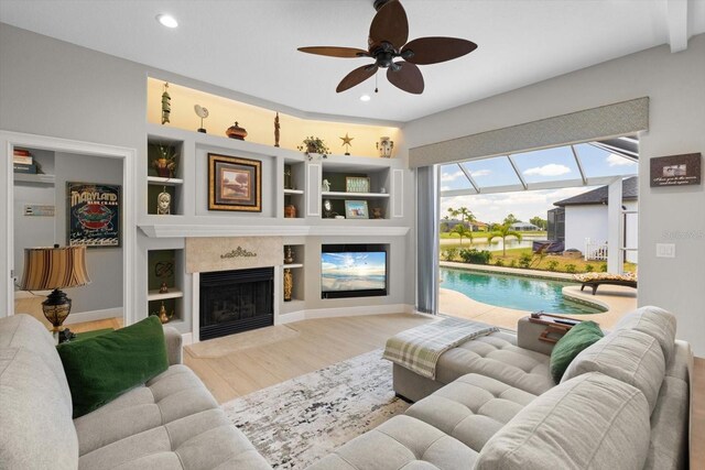 9012 Province St, Sarasota, FL 34240 - living room with wood finished floors, a ceiling fan, a high end fireplace, recessed lighting, and built in features