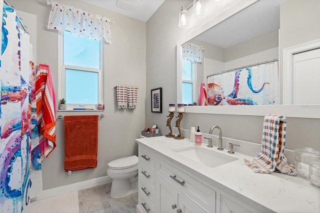 9012 Province St, Sarasota, FL 34240 - bathroom featuring baseboards, plenty of natural light, toilet, and vanity