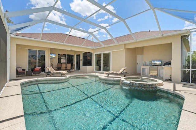 9012 Province St, Sarasota, FL 34240 - view of swimming pool featuring a patio, a pool with connected hot tub, glass enclosure, and an outdoor kitchen