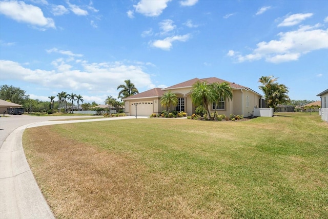 9012 Province St, Sarasota, FL 34240 - view of front of property featuring concrete driveway, a garage, a front yard, and stucco siding
