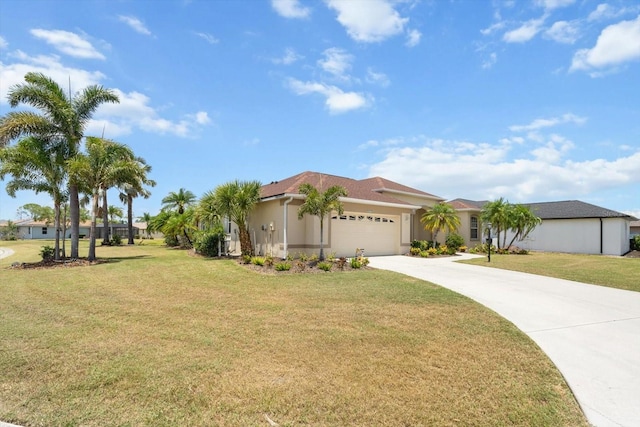 9012 Province St, Sarasota, FL 34240 - view of front facade featuring an attached garage, concrete driveway, a front yard, and stucco siding