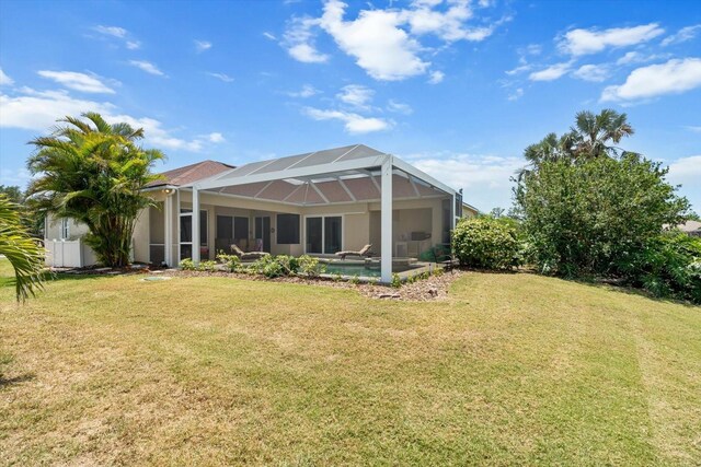 9012 Province St, Sarasota, FL 34240 - back of property with a lawn, a lanai, and stucco siding