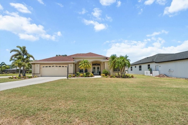 9012 Province St, Sarasota, FL 34240 - mediterranean / spanish house featuring french doors, an attached garage, driveway, a front lawn, and stucco siding