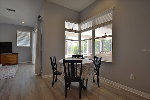 dining area with baseboards, recessed lighting, wood finished floors, and visible vents