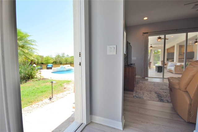 doorway to outside with recessed lighting, ceiling fan, baseboards, and wood finished floors