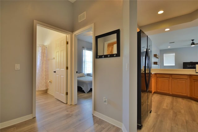 corridor featuring visible vents, recessed lighting, light wood-style flooring, and baseboards