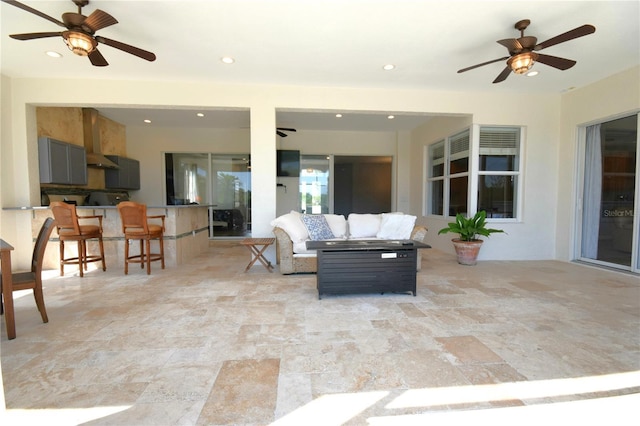 view of patio / terrace with an outdoor hangout area, a ceiling fan, and an outdoor bar