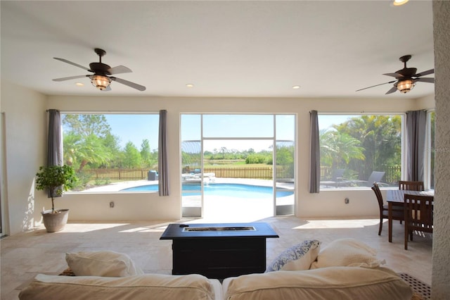 living area featuring a ceiling fan and recessed lighting