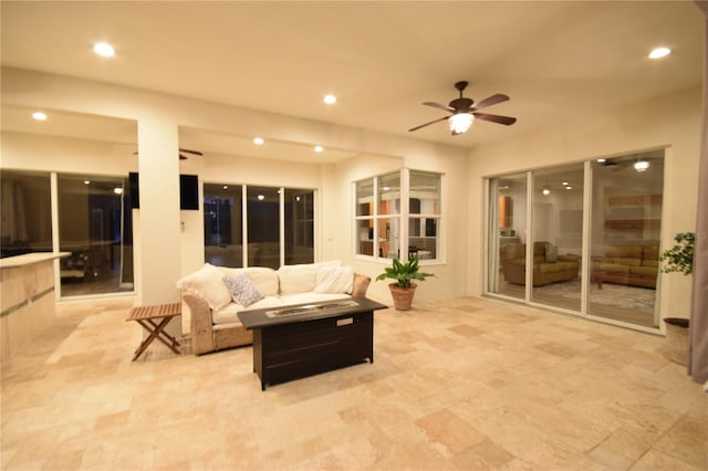 living area featuring a ceiling fan and recessed lighting