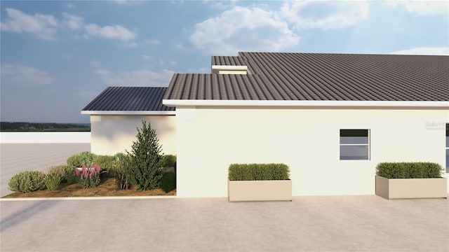 12535 Estrella Blvd, Punta Gorda, FL 33955 - view of side of home with a standing seam roof, stucco siding, and metal roof