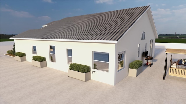 12541 Estrella Blvd, Punta Gorda, FL 33955 - view of side of property with a standing seam roof, a patio area, and stucco siding