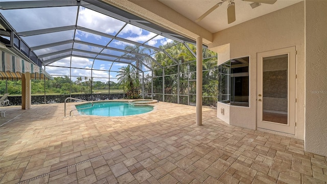 view of pool with a ceiling fan, a patio, a pool with connected hot tub, and glass enclosure