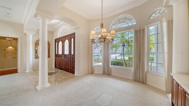 foyer entrance featuring light colored carpet, crown molding, a wealth of natural light, and an inviting chandelier