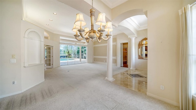 interior space with crown molding, arched walkways, carpet, and a notable chandelier