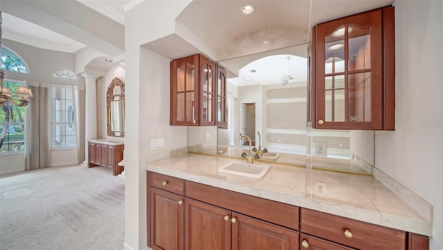 bathroom featuring crown molding, decorative columns, and vanity