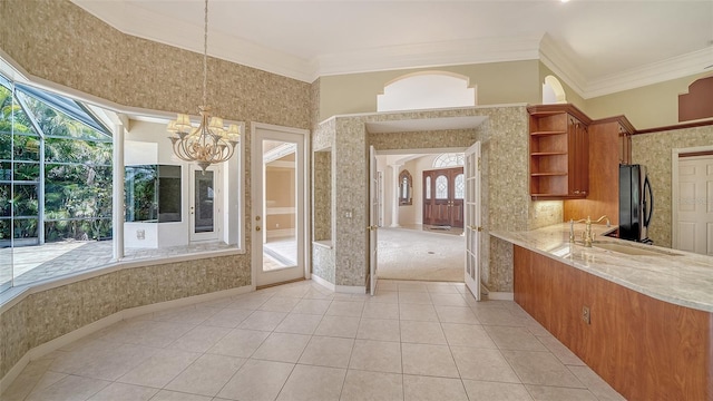 interior space featuring crown molding, tile patterned floors, an inviting chandelier, and vanity