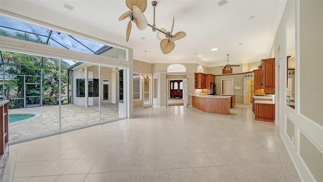 unfurnished living room with crown molding, ceiling fan, light tile patterned floors, and visible vents