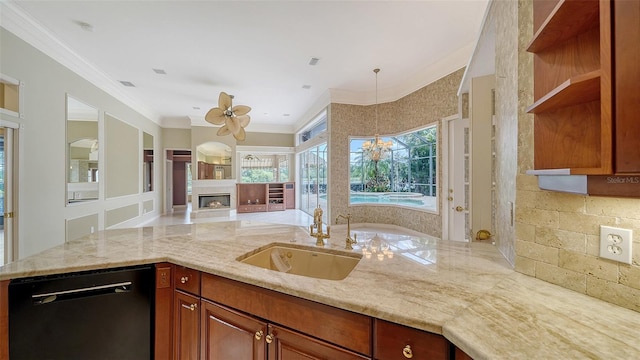 kitchen featuring a glass covered fireplace, open floor plan, light stone counters, a sink, and dishwasher