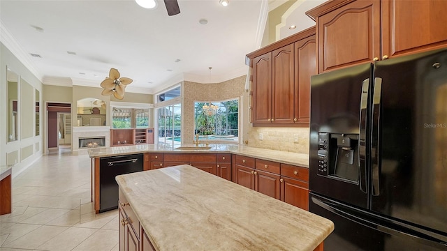 kitchen with a peninsula, backsplash, a lit fireplace, ornamental molding, and black appliances