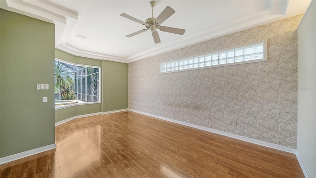 unfurnished room with baseboards, a ceiling fan, wallpapered walls, and wood finished floors
