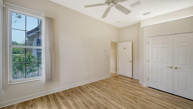 unfurnished bedroom with baseboards, visible vents, light wood finished floors, and a closet