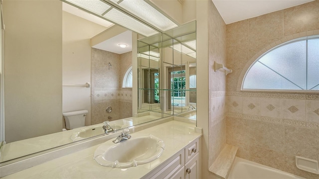 full bath featuring vanity, plenty of natural light, and toilet
