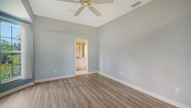 unfurnished room with visible vents, light wood-style floors, baseboards, and a wealth of natural light