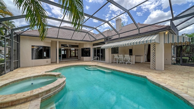 view of pool with a patio, a lanai, and a pool with connected hot tub
