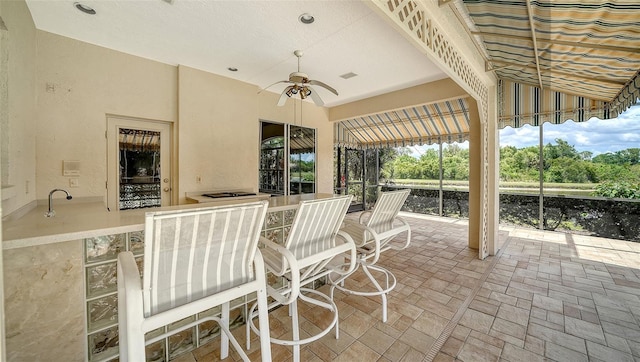 view of patio with a ceiling fan and outdoor dining area