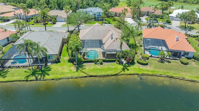 drone / aerial view featuring a water view and a residential view