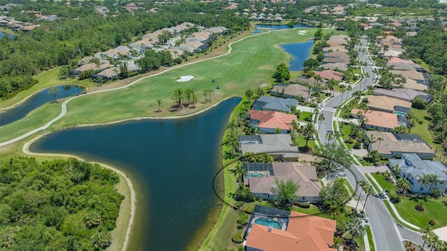drone / aerial view with a residential view, a water view, and golf course view