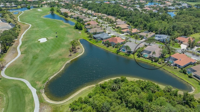 drone / aerial view with a water view, view of golf course, and a residential view
