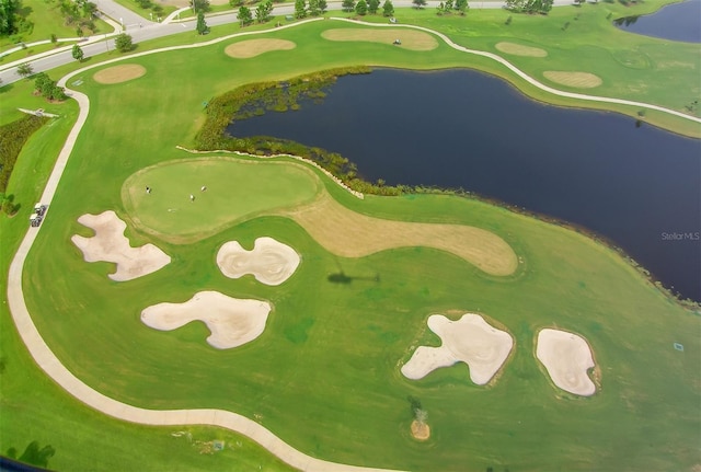 drone / aerial view featuring a water view and golf course view