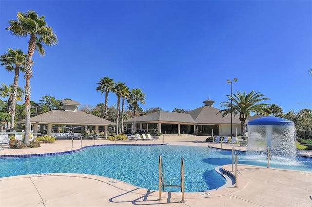 community pool with a patio and a gazebo