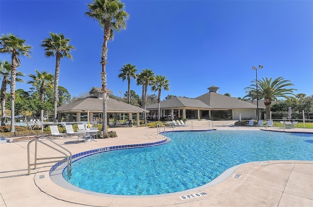 pool with a gazebo and a patio area